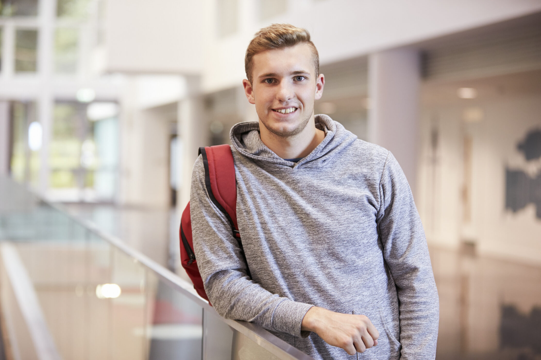 Young adult male student in the lobby of a university